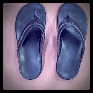 Coveted Okukai mea ola black leather flip flops